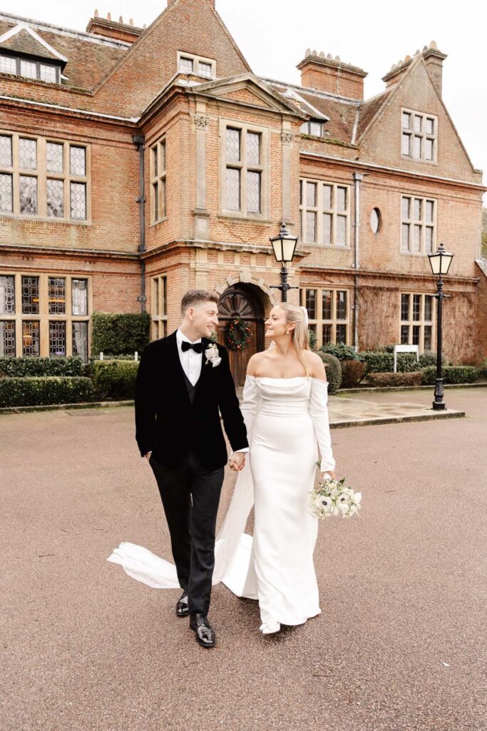 bride and groom portrait in front of horwood house in winter wedding