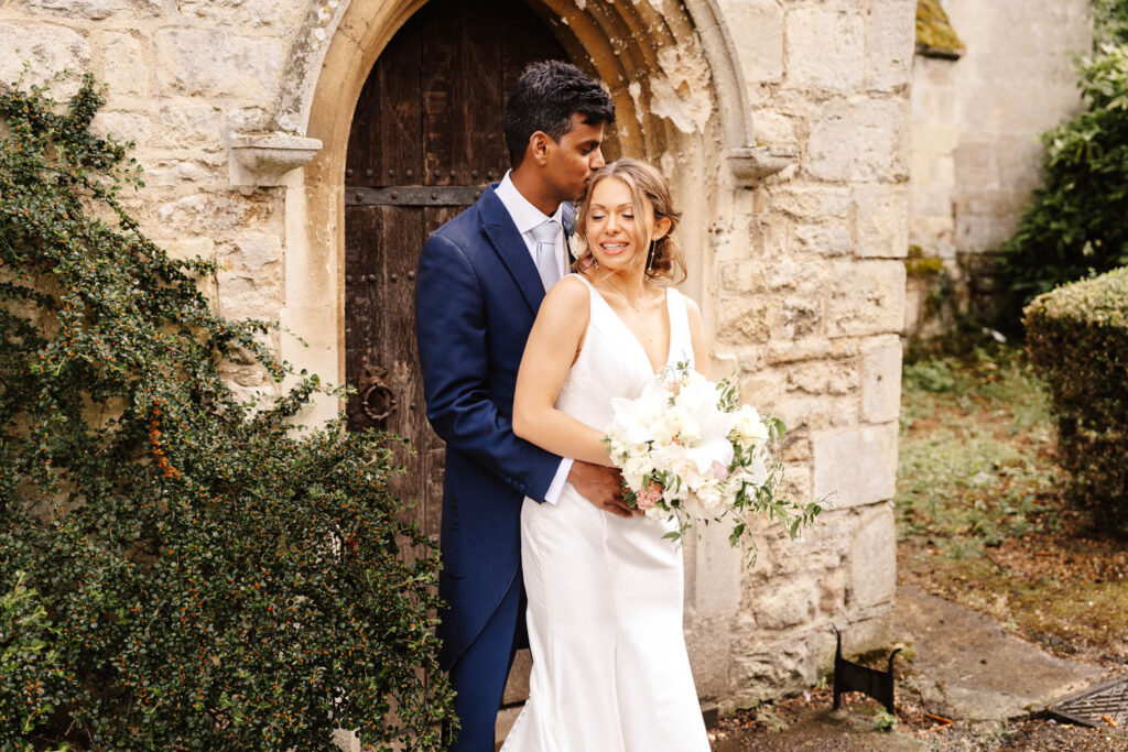 bride and groom portrait outside wooden door at notley abbey