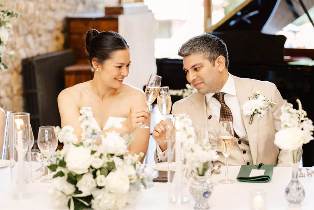 bride and groom during wedding speeches in monks refectory at notley abbey