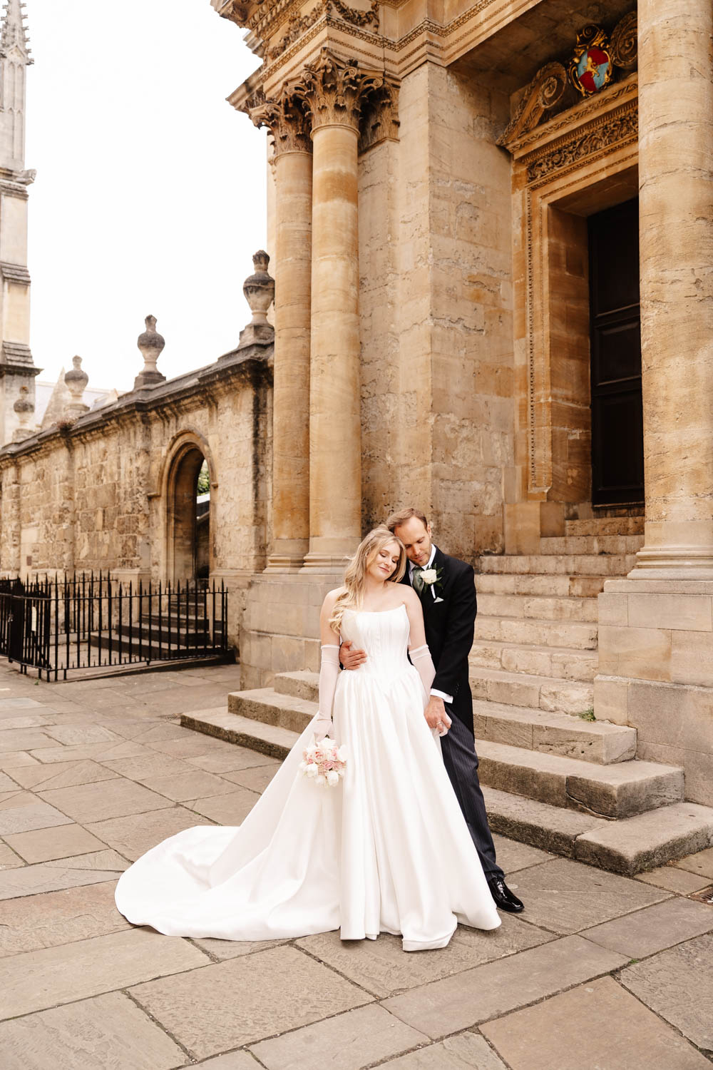bride and groom in black tie outside the langley wedding venue