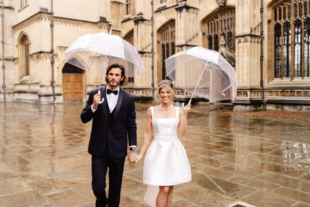 bride and groom walking in the rain on their wedding day
