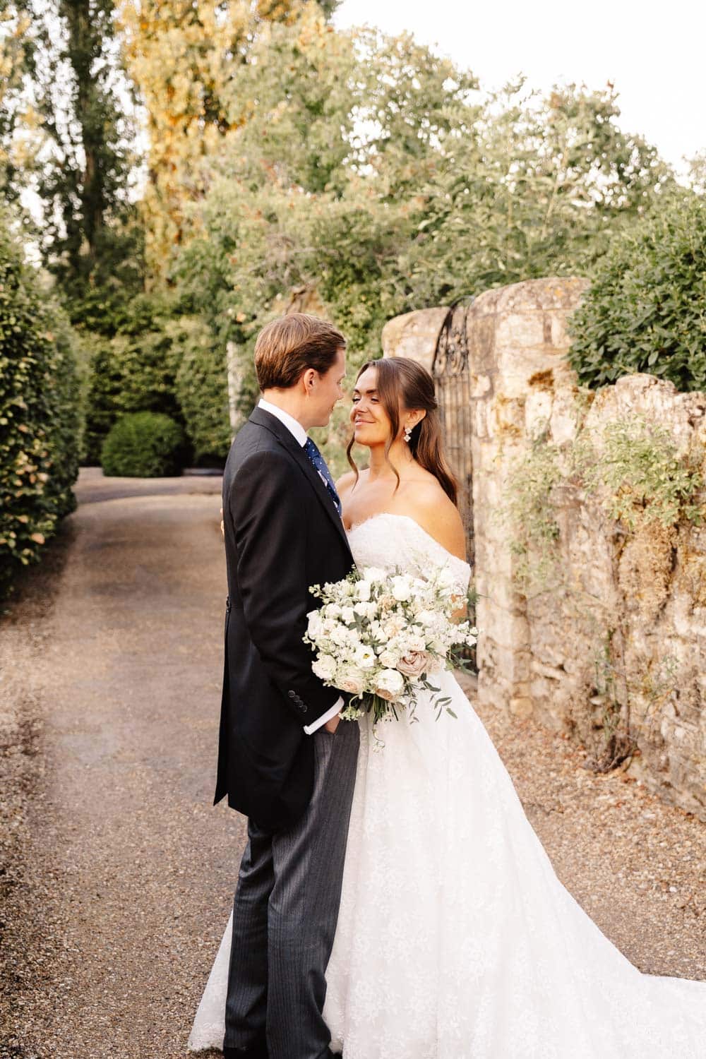 couple in bourton house gardens in the cotswolds during engagement photo shoot